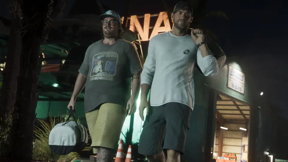 Cal Hampton and a friend walk out at night carrying bags.