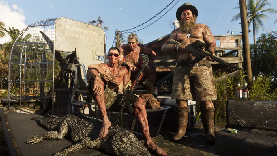 Three hunters covered in mud pose on an airboat in the Grassrivers.