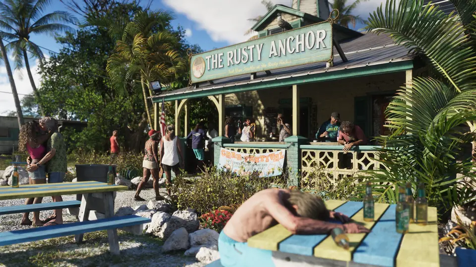 The Rusty Anchor, a beach bar in the Leonida Keys, with a man asleep at a picnic table.