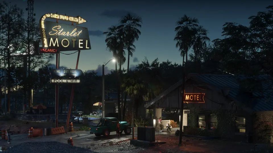 A motel in Port Gellhorn at night, its vacancy sign lit.