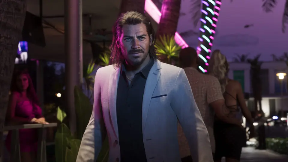 Raul Bautista in a white jacket at a party at night.