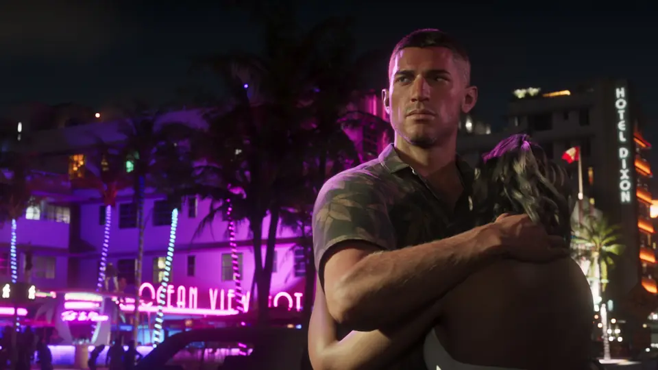 Jason outside a neon hotel at night.