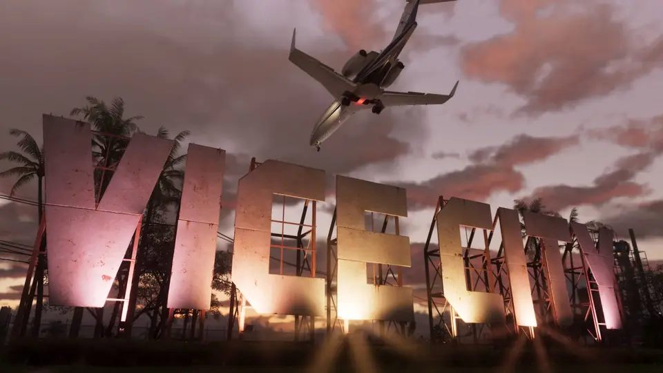 A jet flies low over the giant Vice City sign at sunset.