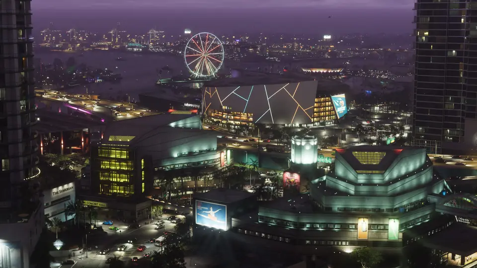 The Vice City skyline at night, with a ferris wheel lit up by the water.